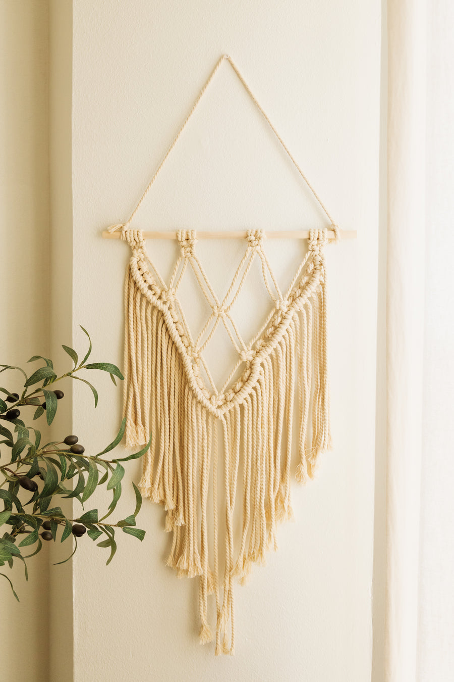 A cream colored cord is used by our artisan partners. Dimensions: About 38in hanging and 16in wide